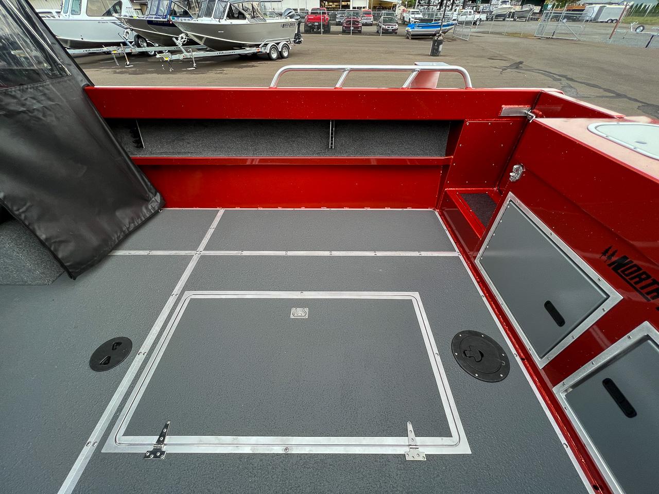 Slide: The Image of 2024 North River 23 SeaHawk boat interior with red accents and storage compartments. - 16