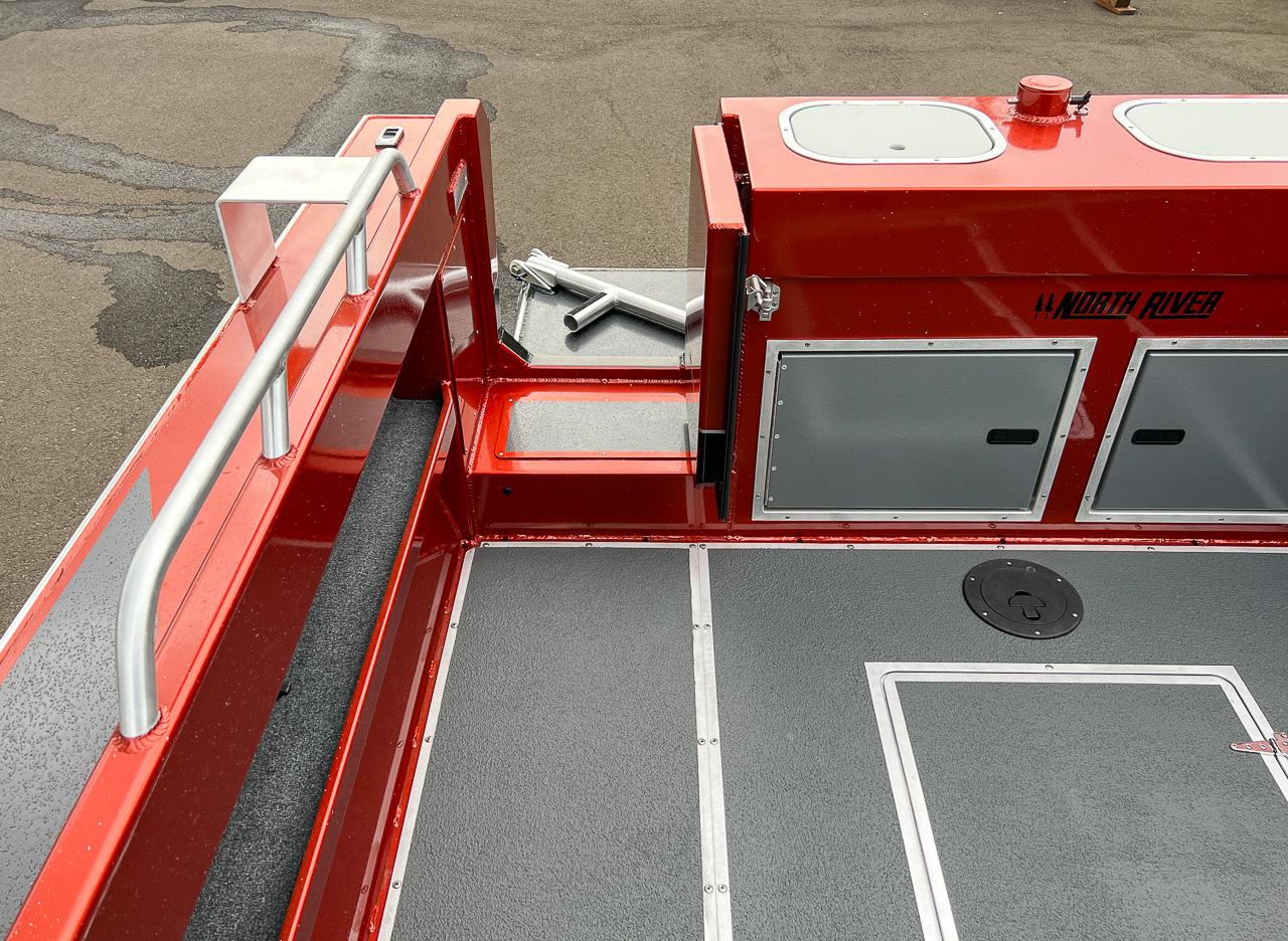 Slide: The Image of 2024 North River 23 SeaHawk boat interior, red and gray deck with storage compartments. - 19