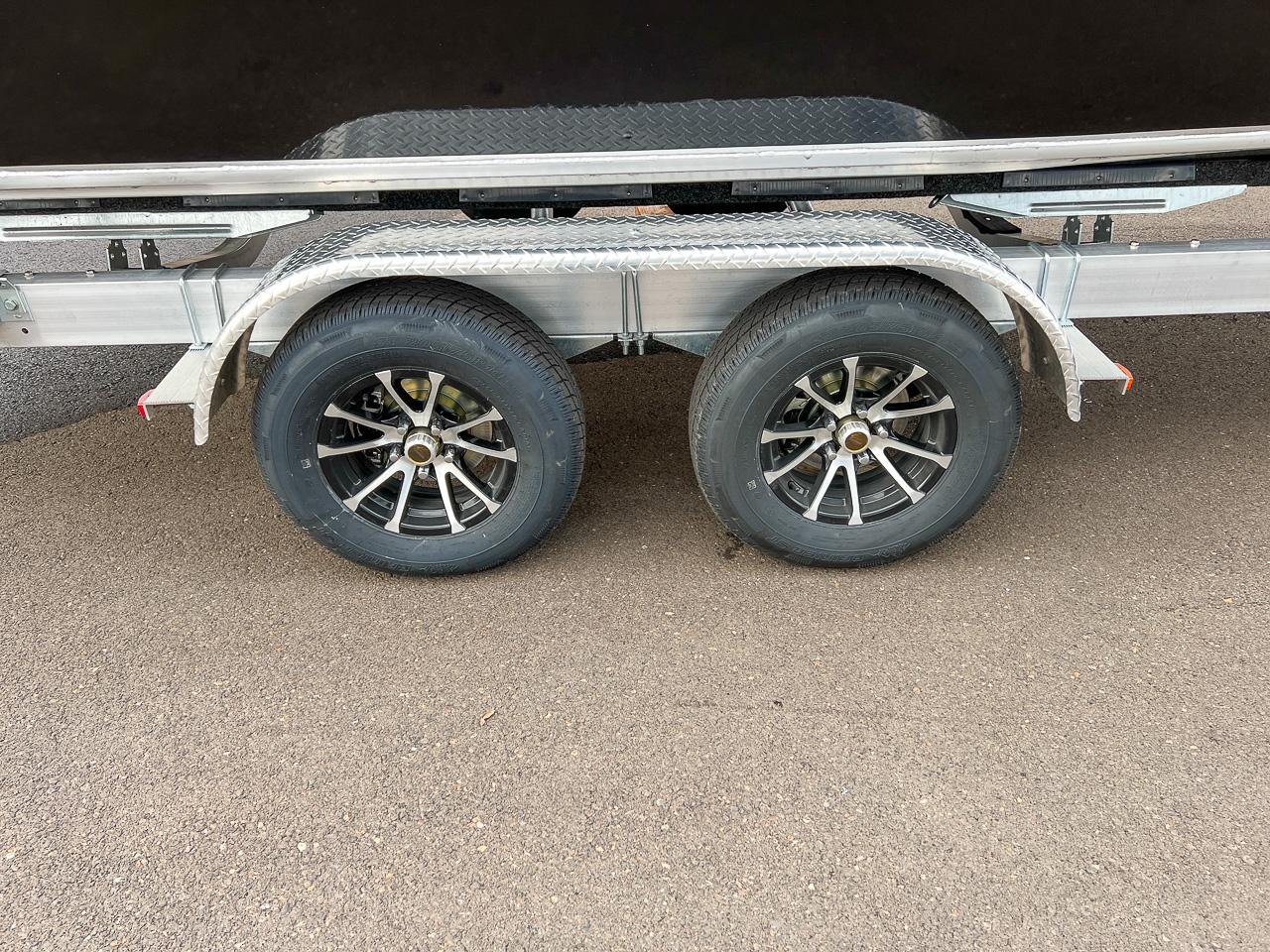 Slide: The Image of Dual axle trailer for 2024 North River 23 SeaHawk boat on asphalt. - 23