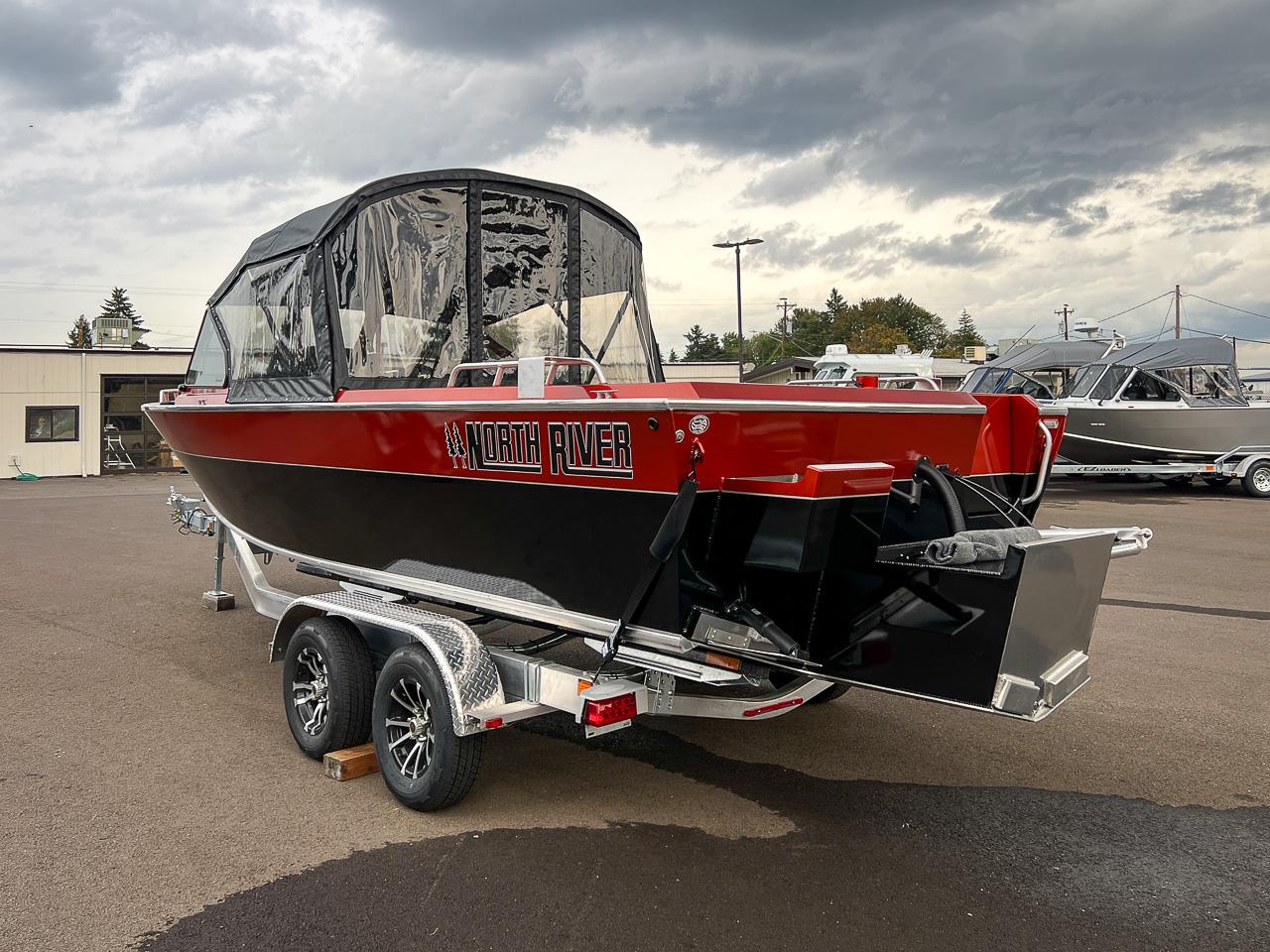 Slide: The Image of 2024 North River 23 SeaHawk boat on a trailer, red and black exterior. - 5