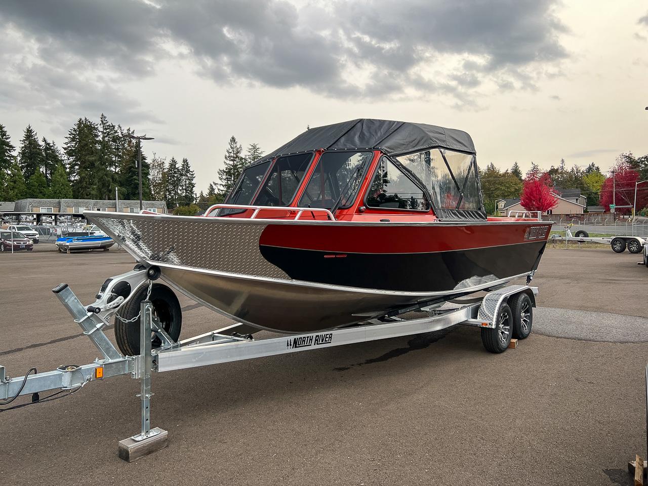 Slide: The Image of 2024 North River 23 SeaHawk boat on a trailer in a parking lot. - 6