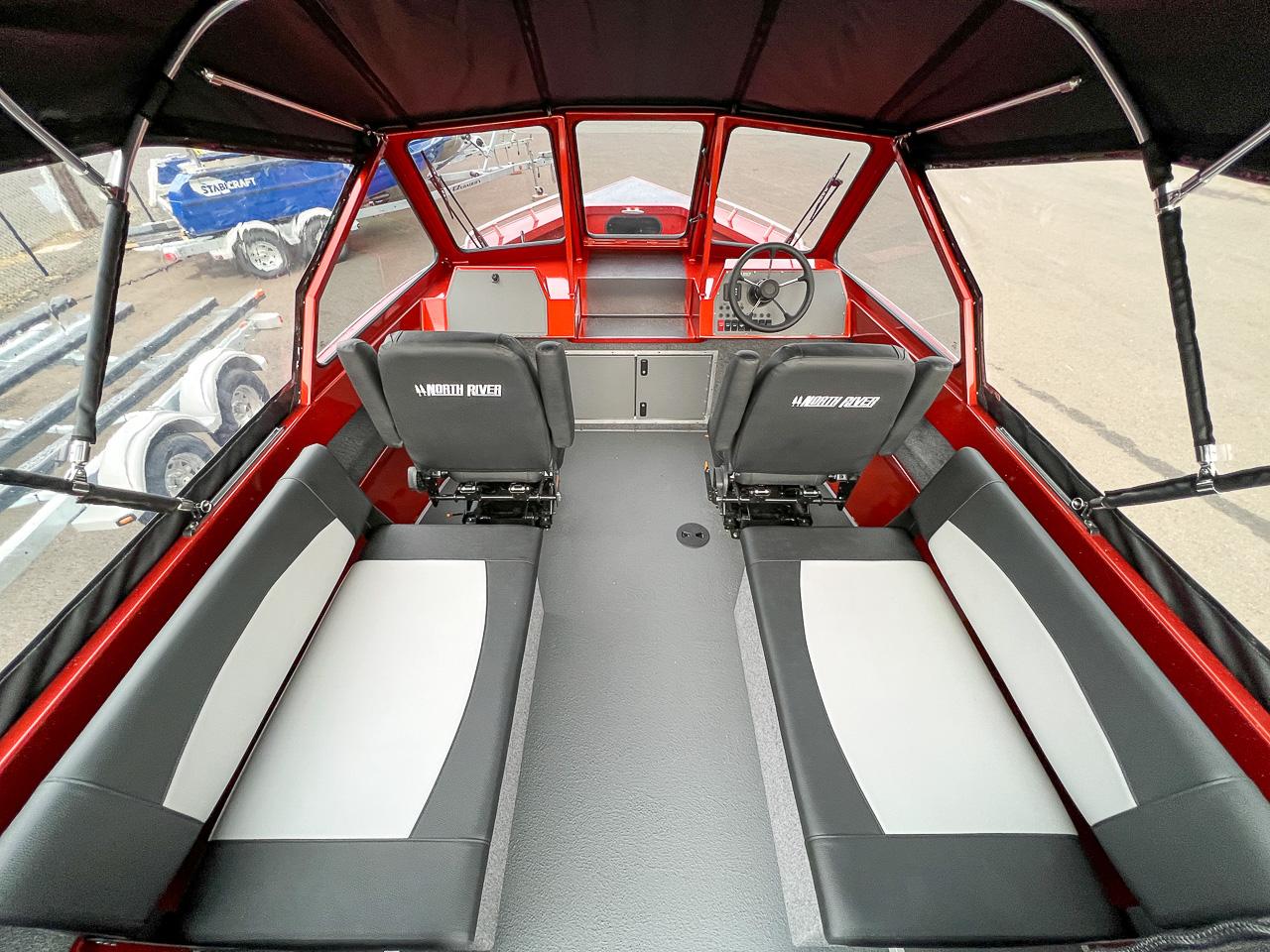 Slide: The Image of Interior of 2024 North River 23 SeaHawk boat with seating and steering console. - 7