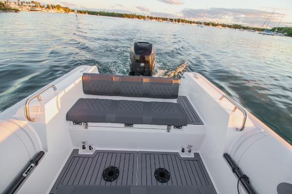 Slide: The Image of 2024 Northstar Orion 8 boat interior with seating and outboard motor on water. - 13