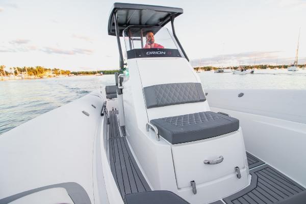 Slide: The Image of 2024 Northstar Orion 8 boat on water with cushioned seating and console. - 8
