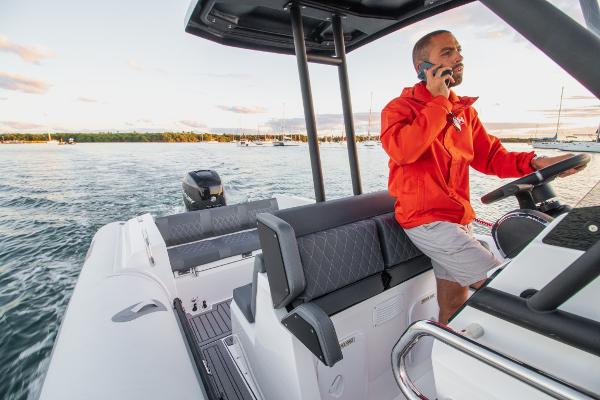 Slide: The Image of 2024 Northstar Orion 8 boat on water, man steering and talking on phone. - 9
