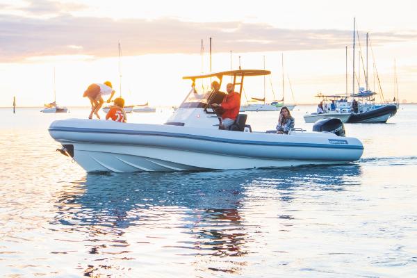 Slide: The Image of 2024 Northstar Orion 8 boat cruising on water at sunset with passengers. - 17