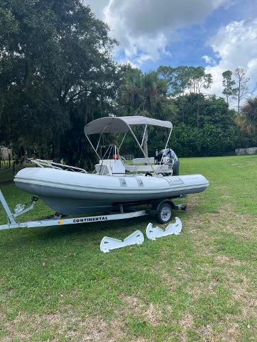 Slide: The Image of 2020 Novurania 460 DL inflatable boat on a Continental trailer in a grassy area. - 1