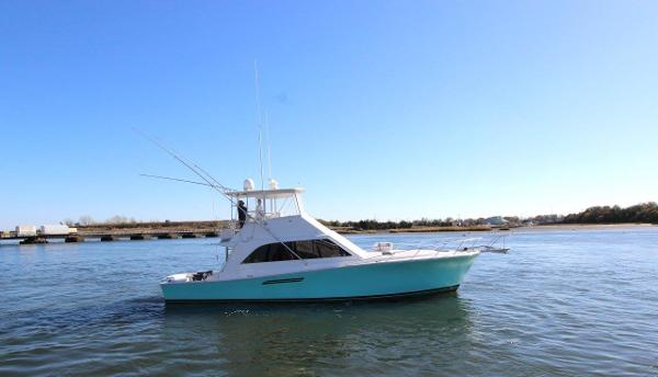 Slide: The Image of 1990 Ocean Yachts 48 Super Sport on calm water. - 0