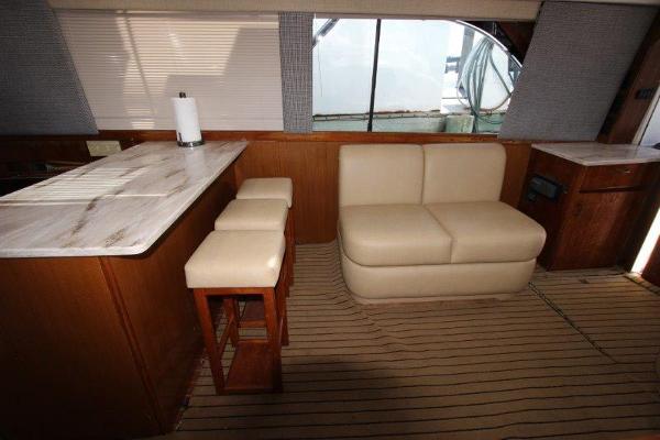 Slide: The Image of Interior of 1990 Ocean Yachts 48 Super Sport with beige seating and wooden accents. - 14