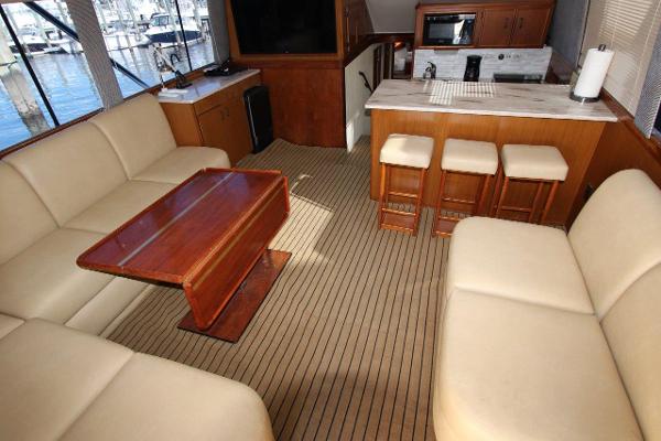 Slide: The Image of Interior of 1990 Ocean Yachts 48 Super Sport with beige seating and wooden table. - 15