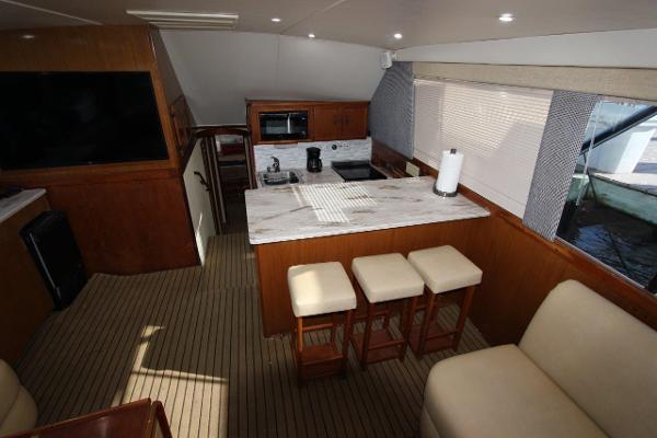 Slide: The Image of Interior of 1990 Ocean Yachts 48 Super Sport with kitchen and seating area. - 16