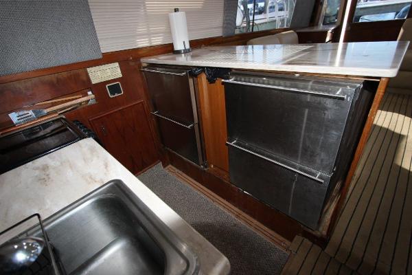 Slide: The Image of 1990 Ocean Yachts 48 Super Sport kitchen with stainless steel appliances and sink. - 17