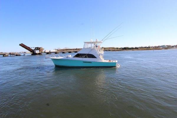 Slide: The Image of 1990 Ocean Yachts 48 Super Sport cruising on calm waters. - 2