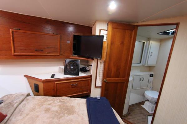 Slide: The Image of Interior cabin of 1990 Ocean Yachts 48 Super Sport with bed, TV, and bathroom. - 20