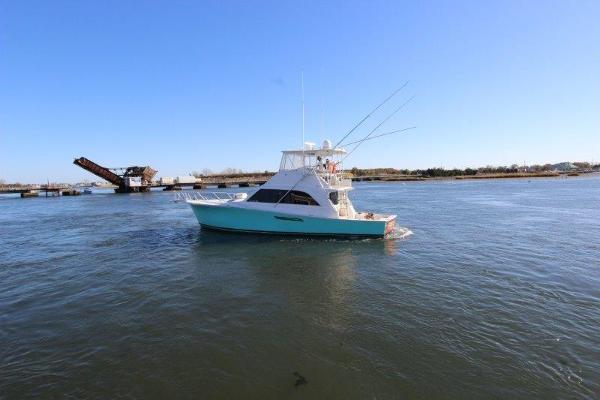 Slide: The Image of 1990 Ocean Yachts 48 Super Sport cruising on open water. - 3