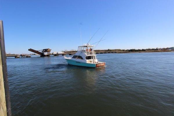 Slide: The Image of 1990 Ocean Yachts 48 Super Sport cruising on a calm river. - 4