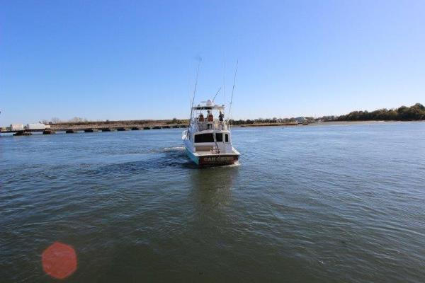 Slide: The Image of 1990 Ocean Yachts 48 Super Sport cruising on a calm river. - 5