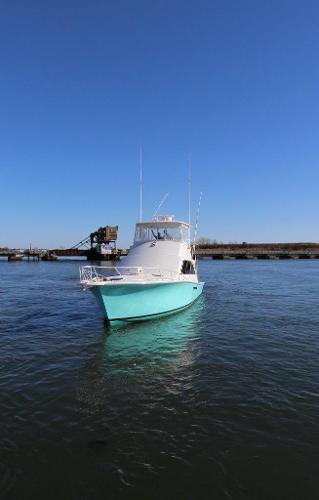 Slide: The Image of 1990 Ocean Yachts 48 Super Sport on calm water. - 6