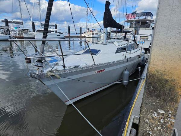 Slide: The Image of 1987 O'Day 322 sailboat docked at a marina. - 1
