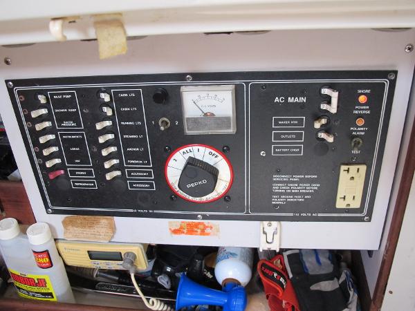 Slide: The Image of 1987 O'Day 322 electrical control panel with switches and AC main. - 14