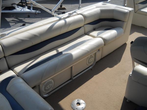 Slide: The Image of 2004 Odyssey Millennium 2502M boat interior with beige and blue cushioned seating. - 11