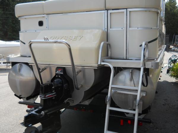 Slide: The Image of 2004 Odyssey Millennium 2502M pontoon boat rear view with motor and ladder. - 20