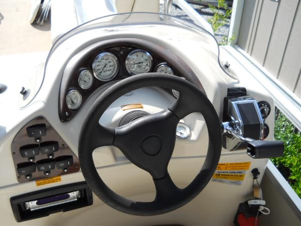 Slide: The Image of 2004 Odyssey Millennium 2502M boat dashboard with steering wheel and control panel. - 7