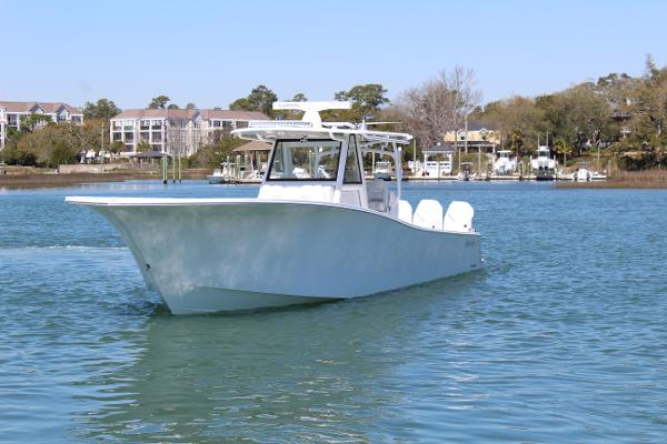 Slide: The Image of 2021 Onslow Bay 41 Tournament Edition boat on calm water. - 1