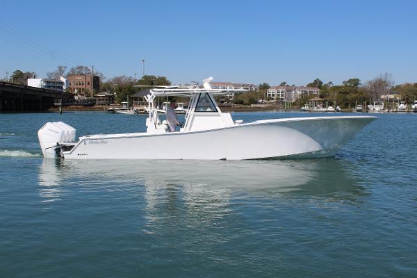 Slide: The Image of 2021 Onslow Bay 41 Tournament Edition boat cruising on a calm waterway. - 12