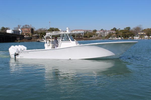 Slide: The Image of 2021 Onslow Bay 41 Tournament Edition boat on calm water. - 13