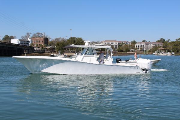 Slide: The Image of 2021 Onslow Bay 41 Tournament Edition boat cruising on a calm river. - 2