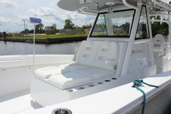 Slide: The Image of 2021 Onslow Bay 41 Tournament Edition boat with white seating and water backdrop. - 20