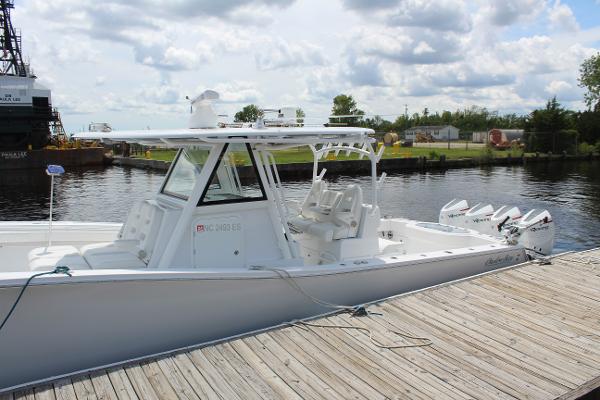 Slide: The Image of 2021 Onslow Bay 41 Tournament Edition boat docked by a wooden pier. - 23