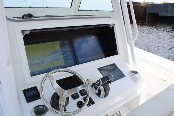 Slide: The Image of 2021 Onslow Bay 41 Tournament Edition boat console with dual navigation screens and steering wheel. - 32
