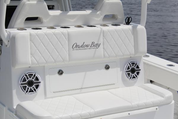 Slide: The Image of 2021 Onslow Bay 41 Tournament Edition boat seating with speakers and rod holders. - 35