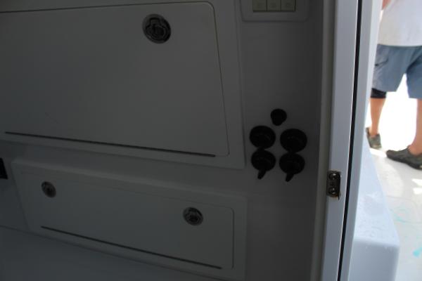 Slide: The Image of 2021 Onslow Bay 41 Tournament Edition boat storage compartments and control panel. - 37