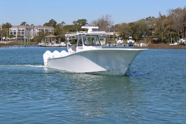 Slide: The Image of 2021 Onslow Bay 41 Tournament Edition boat cruising on a calm lake. - 4