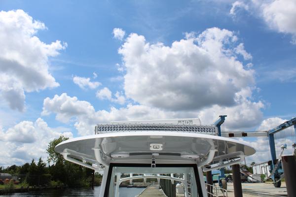 Slide: The Image of 2021 Onslow Bay 41 Tournament Edition boat docked under a partly cloudy sky. - 42