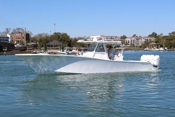 Slide: The Image of 2021 Onslow Bay 41 Tournament Edition boat cruising on a calm waterway. - 5