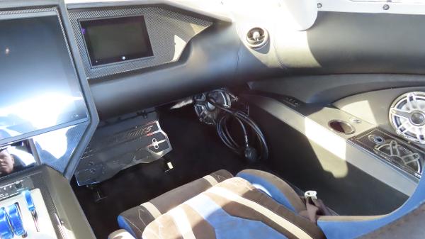 Slide: The Image of 2020 Outerlimits 46SC boat interior dashboard with modern controls and seating. - 27