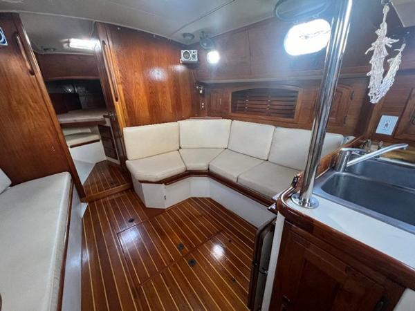 Slide: The Image of Interior of 1986 Pacific Seacraft 37 sailboat with wooden finishes and cozy seating area. - 13