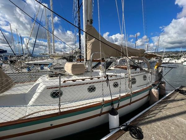 Slide: The Image of 1986 Pacific Seacraft 37 sailboat docked at a marina under a blue sky. - 2