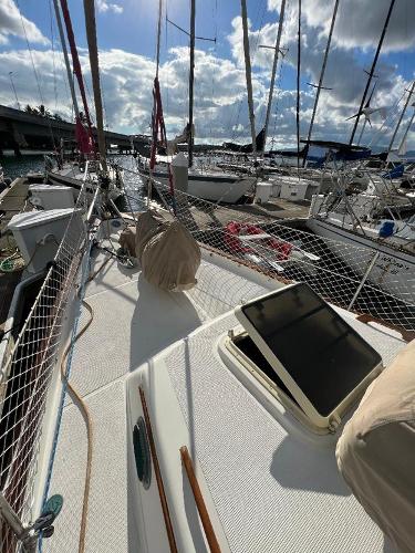 Slide: The Image of 1986 Pacific Seacraft 37 sailboat docked at a marina under a partly cloudy sky. - 7