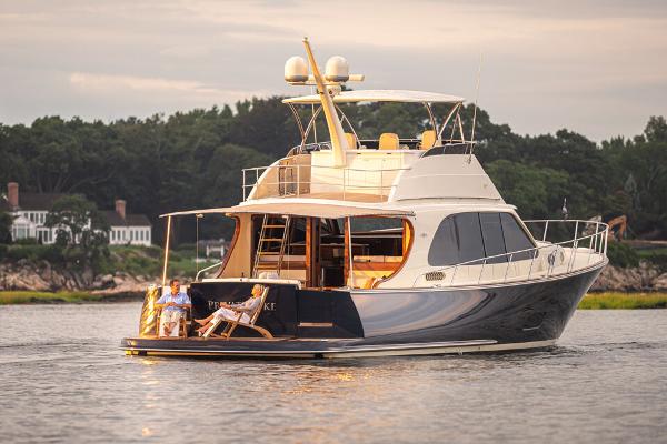 Slide: The Image of 2026 Palm Beach Motor Yachts PB70 cruising on serene waters at sunset. - 4