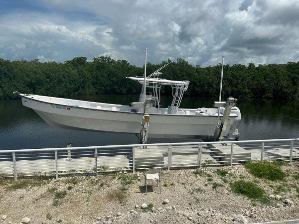 Slide: The Image of 2022 Panga Eduardoño Corvina 32 ft boat docked by a serene river. - 0