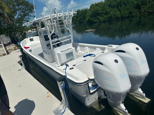 Slide: The Image of 2022 Panga Eduardoño Corvina 32 ft Panga boat docked with twin Yamaha engines. - 2