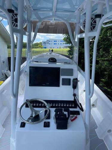 Slide: The Image of 2022 Panga Eduardoño Corvina 32 ft Panga boat dashboard with steering wheel and navigation equipment. - 24