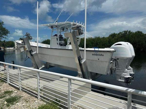 Slide: The Image of 2022 Panga Eduardoño Corvina 32 ft Panga boat docked on a lift by the water. - 3