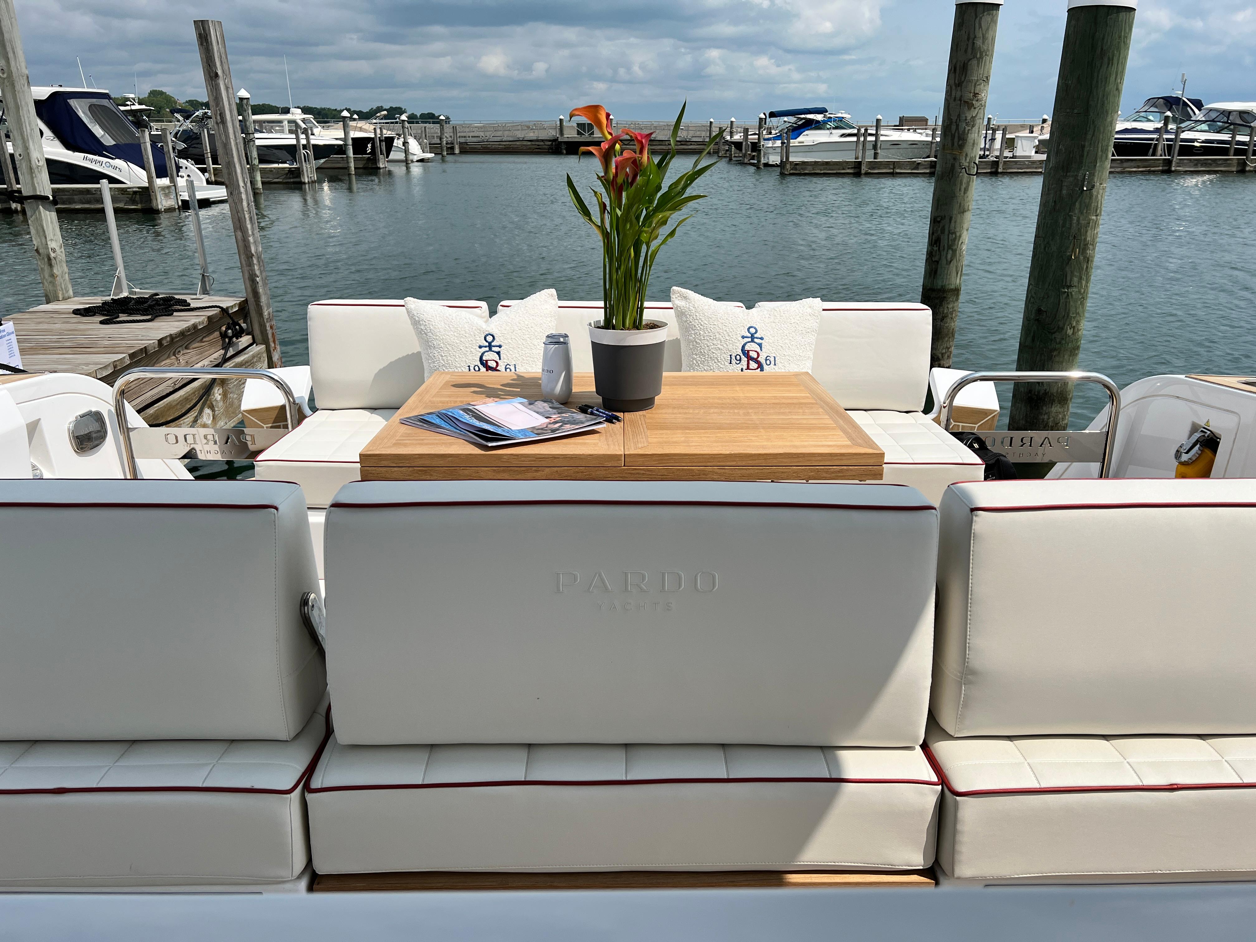 Slide: The Image of Luxury seating area on 2025 Pardo Yachts 38 Outboard, docked at marina. - 14