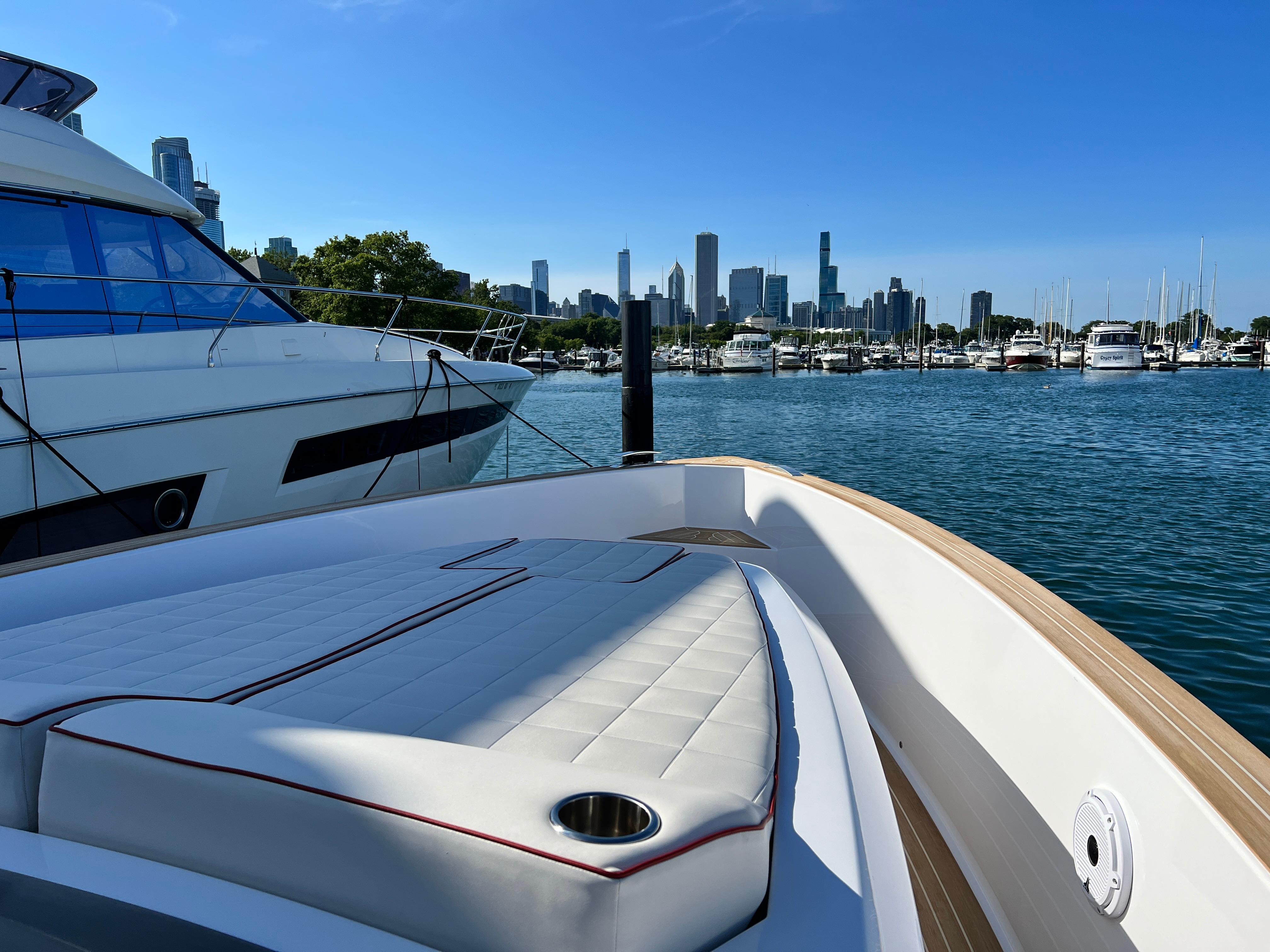Slide: The Image of 2025 Pardo Yachts 38 Outboard in marina, city skyline in background. - 18